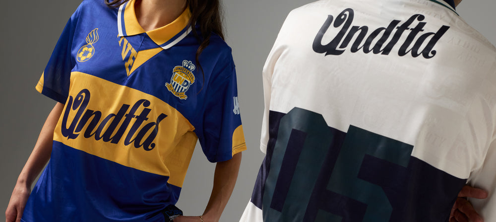 Two sports jerseys, one blue and yellow with 'UNDFTD' branding, the other white with black text and number '05'.