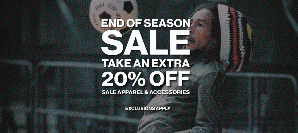 Promotional sale graphic with large white text reading 'END OF SEASON SALE TAKE AN EXTRA 20% OFF SALE APPAREL & ACCESSORIES' over a dark lifestyle scene of a person wearing a knit beanie and looking upward.