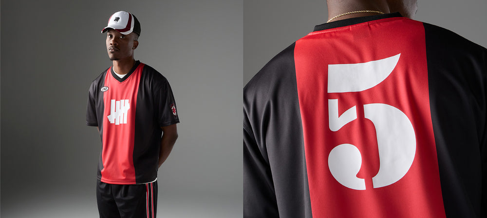 Person wearing a black and red sports jersey with number 5 on a gray background