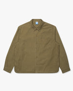 OLIVE::An olive Undefeated Field L/S Workshirt on a white background.