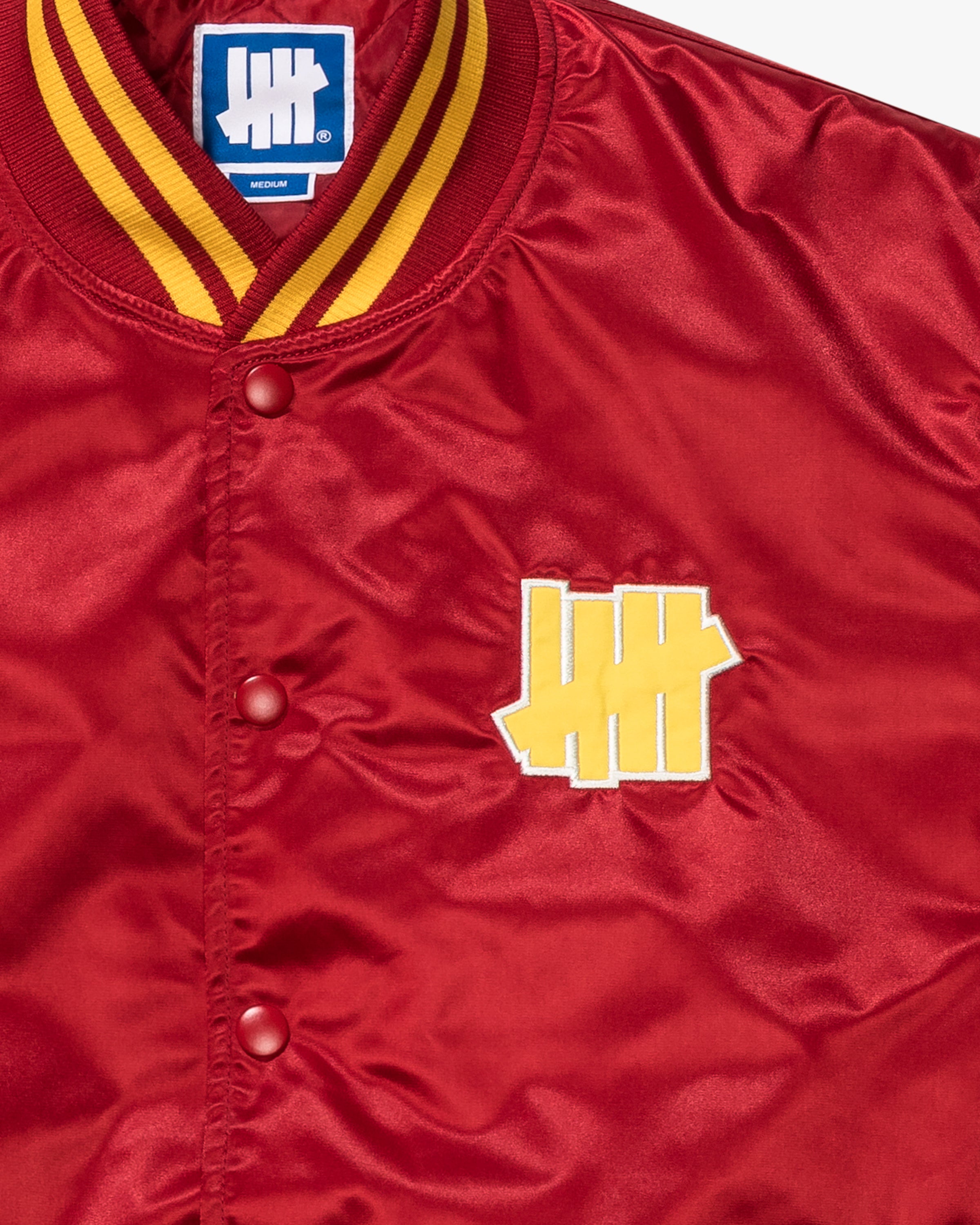 UNDEFEATED ICON SATIN VARSITY JACKET - SCARLET
