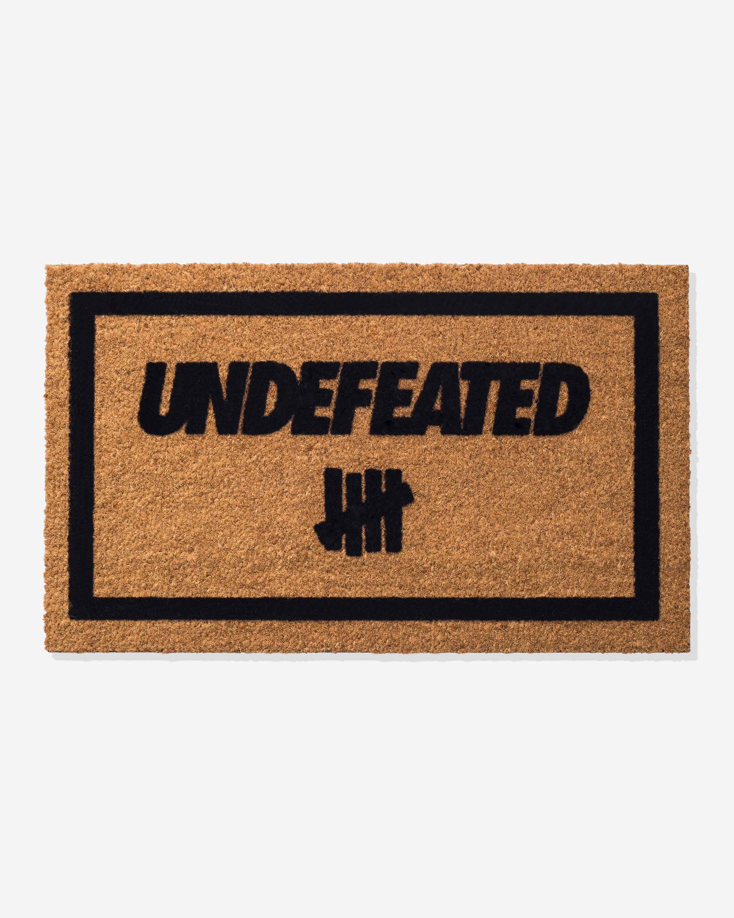 https://undefeated.com/cdn/shop/products/accessories_undefeated_door-mat_2228.color_natural.view_1.jpg?v=1670441496
